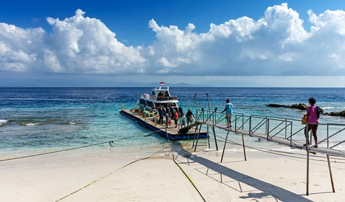 Passengers boarding a Ferry on the beach of Nusa Penida.