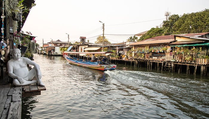 Passenger boat passing by Khlong Bang Luang Floating Market