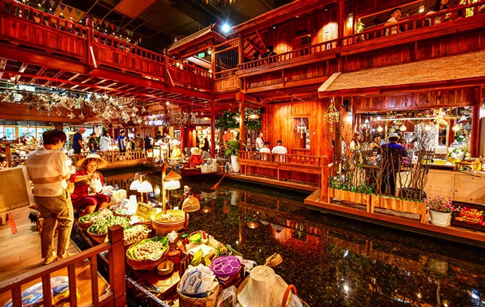 SookSiam floating market area in IconSiam, with a vendor on a boat