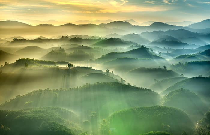 The sun rises over the Dai Lao mountain range in Laos