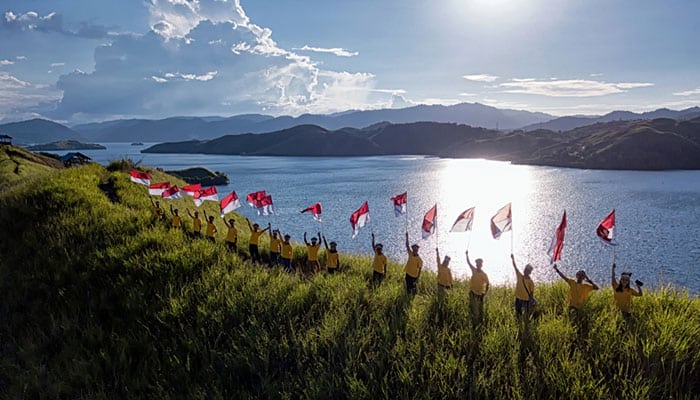 Kids with Indonesia National Flag viewpoint at Hill of Sentani Lake