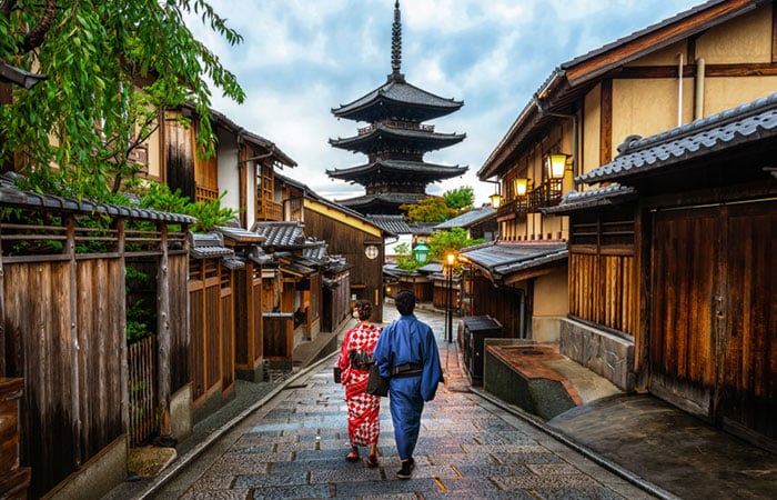 Asian traveler wearing traditional Japanese kimono walking in Higashiyama district in the old town of Kyoto