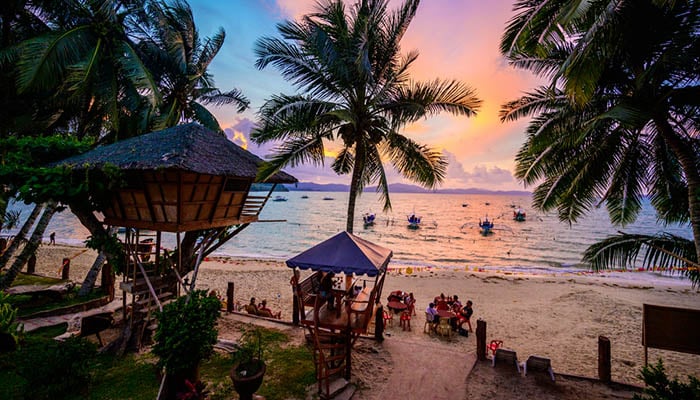 Port Barton Beach at sunset on paradise island, tropical travel destination