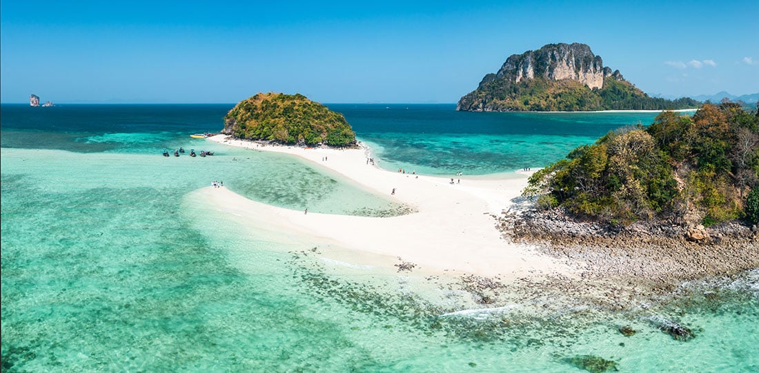 The aerial view from a drone of the "Thale Waek" (Separated Sea) in Krabi, Thailand provides an amazing sight. This area, known as the Koh Dam group, is made up of two large islands - Koh Dam Hok and Koh Dam Kwan.