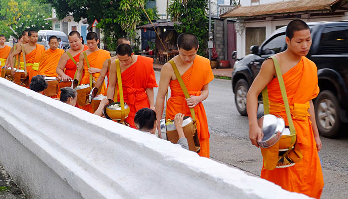 Alms giving in the morning when monks walk by the streets for the food. Luang Prabang, Laos