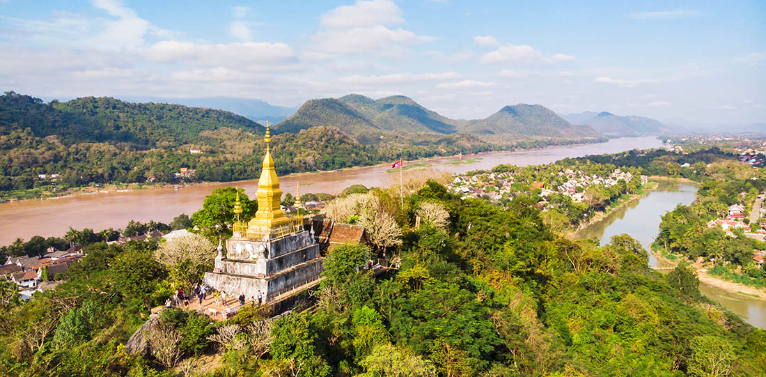 Luang Prang Laos View. Mount Phousi. South East Asia, View of town and surrounding countryside. golden pagoda of Wat Chom Si on the top of Mount Phou Si