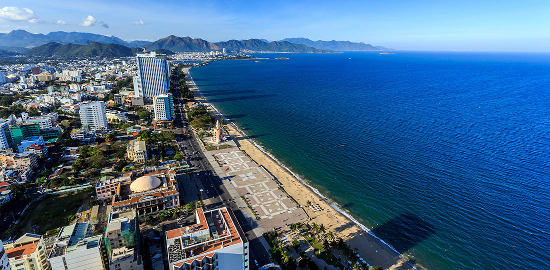 Aerial view over Nha Trang city, Vietnam taken from rooftop, Beautiful day with blue water and many buildings next to the beach