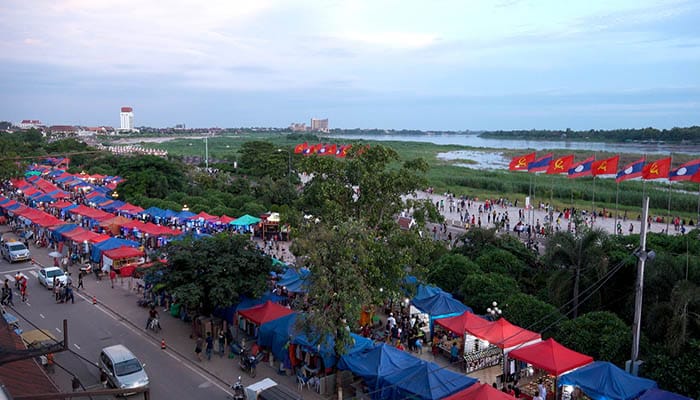 The vibrant night market in Vientiane with Mekong river in the background
