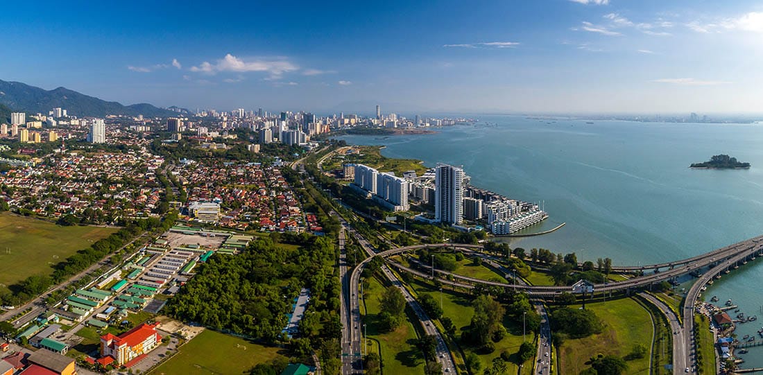Beautiful day with blue sky. Aerial panoramic view of Penang Island from Penang 1st Bridge, Penang, Malaysia.