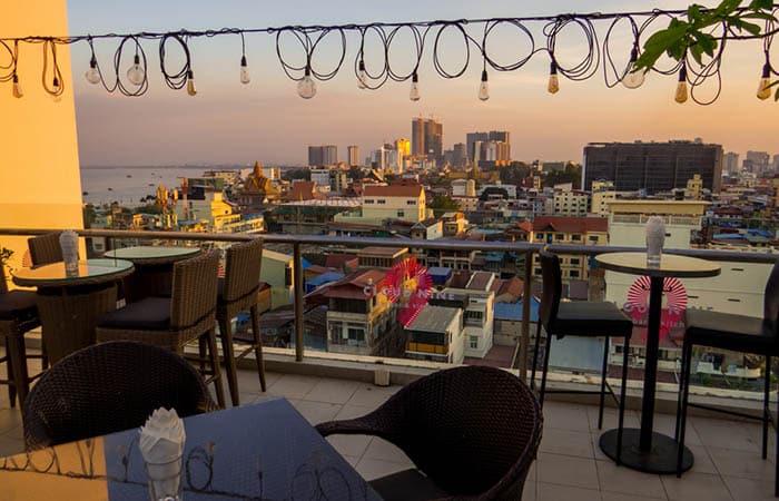 View of the Cloud 9 Sky Bar in Phnom Penh at sunset with view over city.