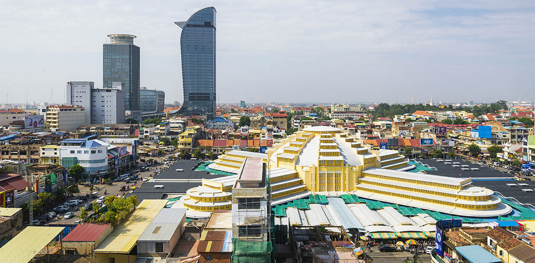 Central Market and tall buildings in Phnom Penh city on a cloudy day