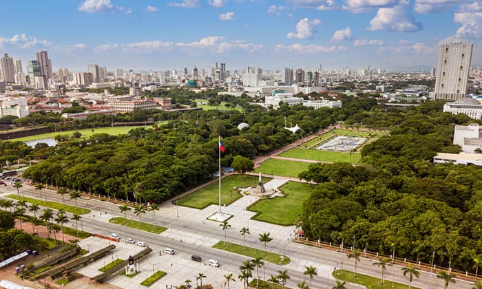 Aerial Rizal Park (Luneta) and the surrounding skyline of Metro Manila.