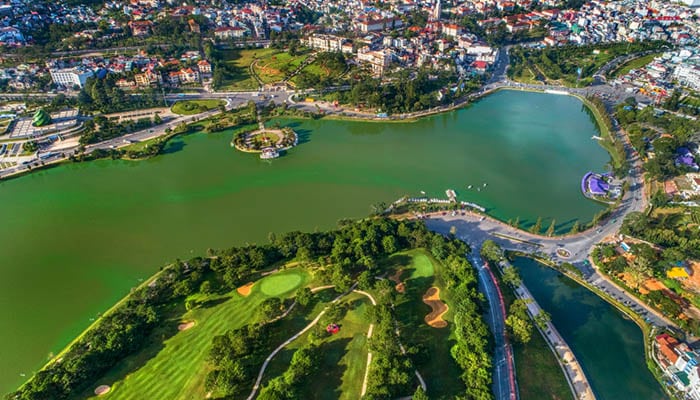 Xuan Huong Lake in Dalat with golf court and city next to it